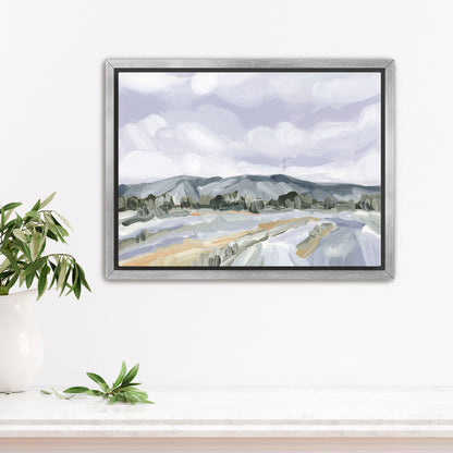 Framed landscape painting depicting mountains, fields, and cloudy sky in muted colors.