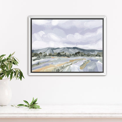 Framed landscape painting depicting mountains, fields, and cloudy sky in muted colors.