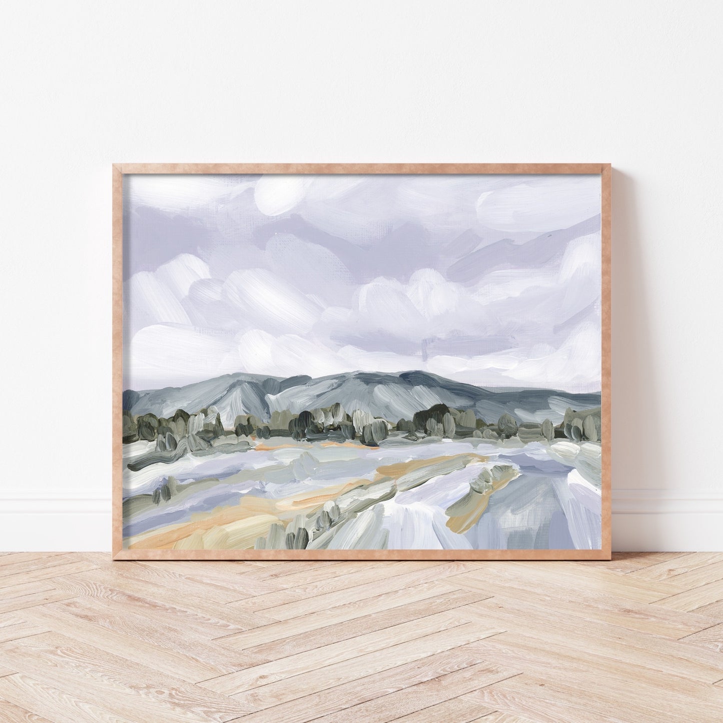 Framed landscape painting depicting mountains, trees, and a winding river or road.