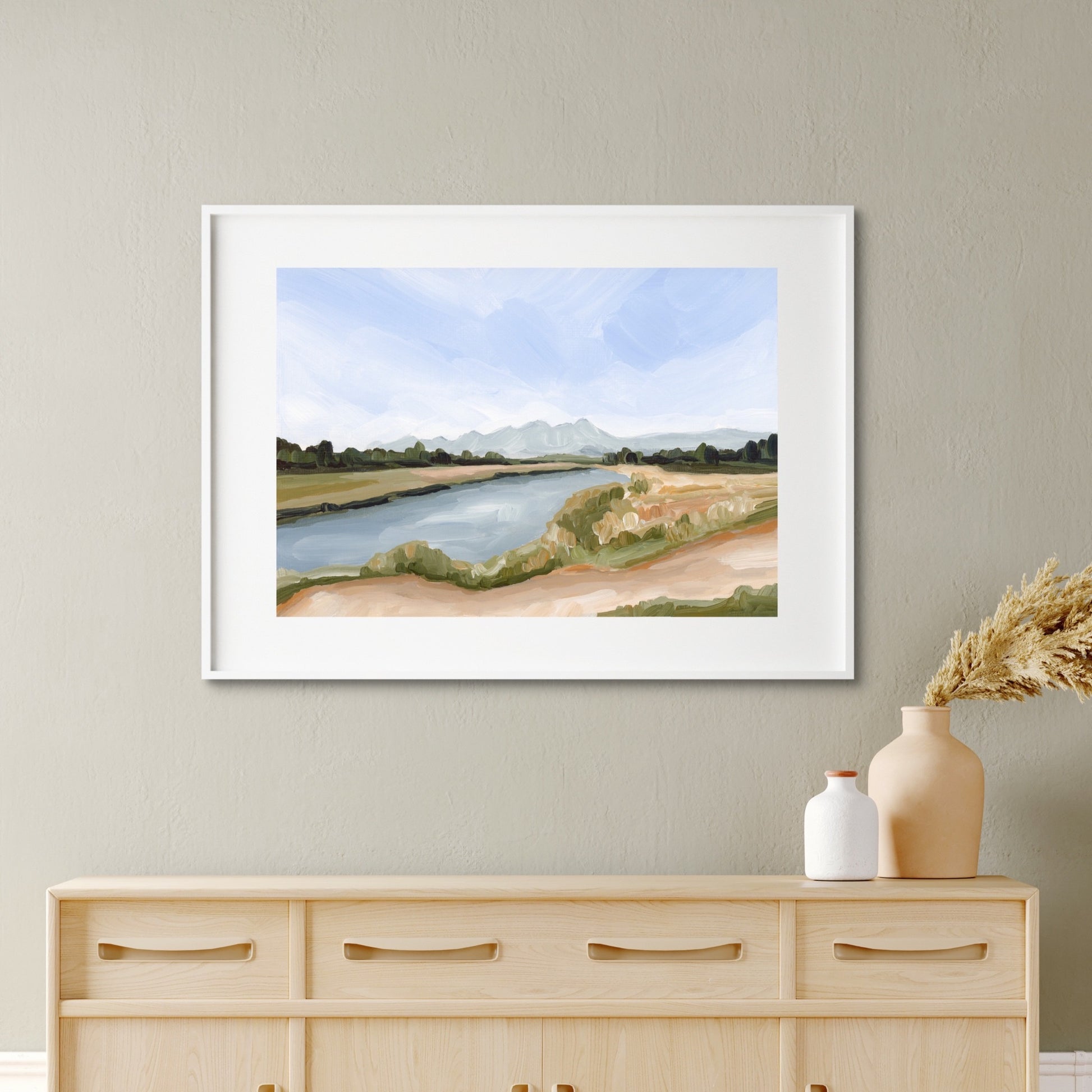 Framed watercolor painting of a serene river landscape.