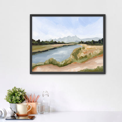 Framed landscape painting depicting a river winding through countryside with distant mountains.