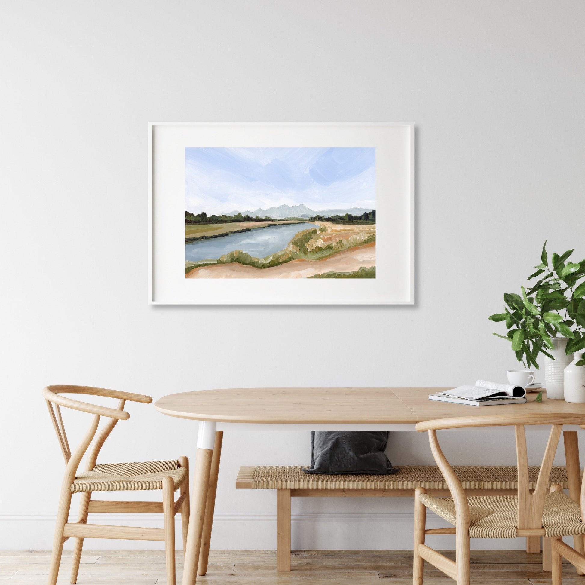 Framed watercolor painting of a serene riverside landscape.