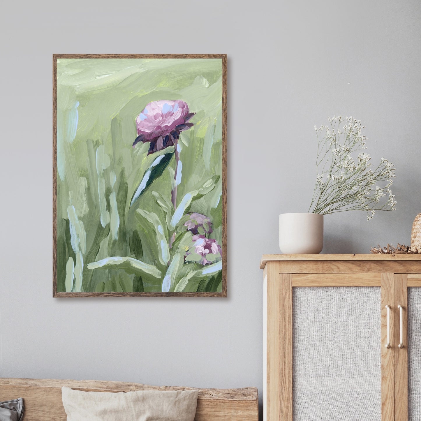 Framed painting of a pink peony flower with green foliage.