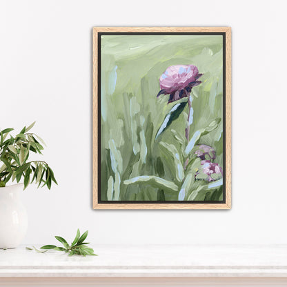 Framed painting of a pink peony flower with green foliage.