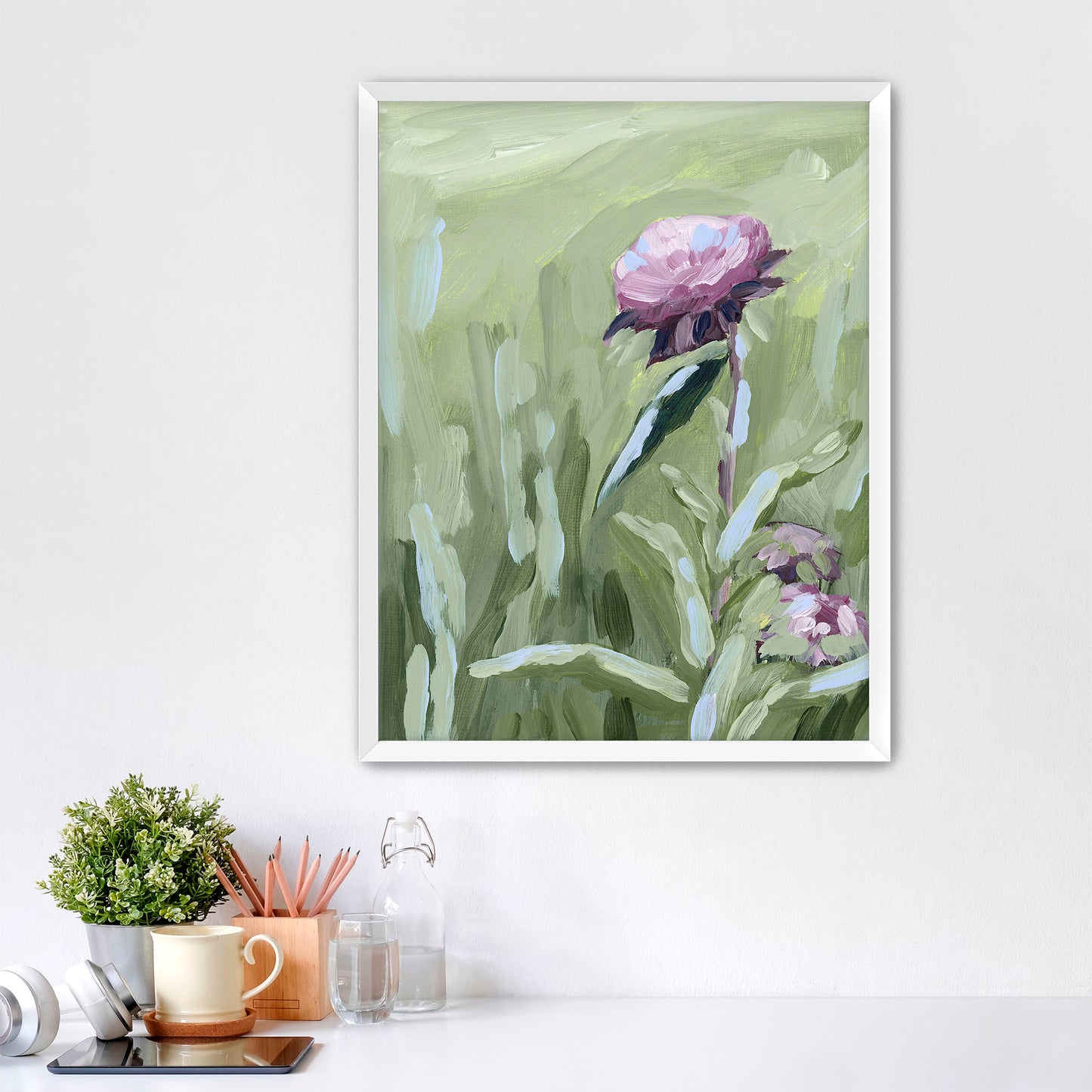 Framed painting of a pink flower with green stems and leaves.