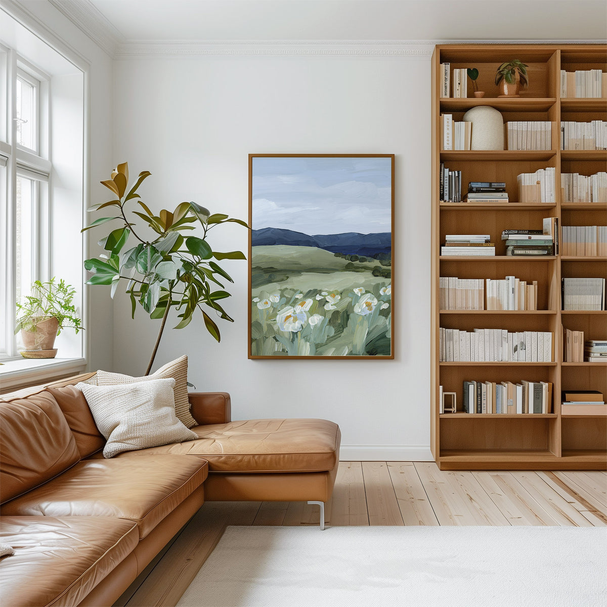 Living room with brown leather sectional sofa, bookshelf, and wall art of Cape Town.