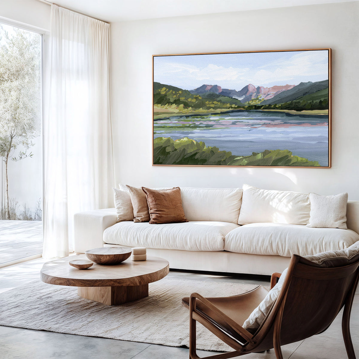 Modern living room with a white sofa, wooden coffee table, and a large landscape painting on the wall.